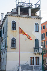 Fototapeta premium Venetian flag in Venice, Italy.march, 2019