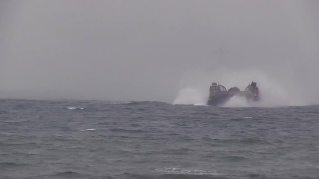 Military hovercraft speeding on the ocean