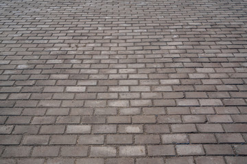 Abstract background of old cobblestone pavement close-up.