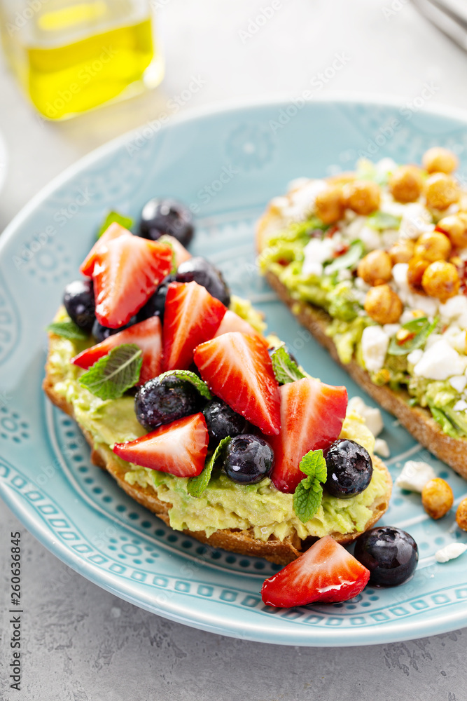 Wall mural Healthy avocado toast duo with chickpeas and fruit - Wall murals