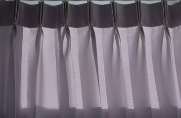 Gray curtains in the bedroom at morning