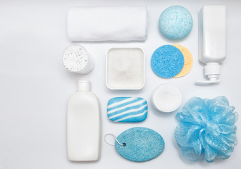 Composition with towel and bath  accessories on white table. Cleansing of the skin health concept. Copy space for text. Top view. 