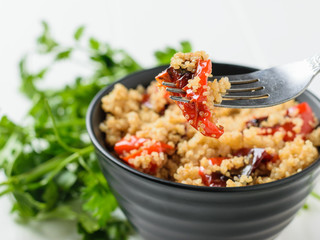 Roasted peppers and cooked quinoa cereal for iron fork. Vegetarian dish.