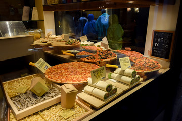 Italian food. Pizzeria window display with Pizza, Pasta, Rolls in Venice Italy restaurant.