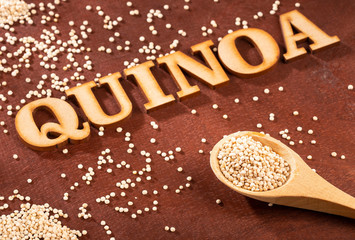 White Quinoa Seeds - Chenopodium quinoa. Wood background