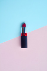 Red lipstick isolated on pastel background, Minimal makeup fashion concept.