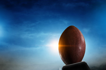 Night football arena in lights with a ball close up