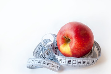 Fresh Apple and measuring tape on white background. Diet concept.