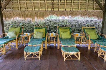 Massage table overlooking the tropical garden. Spa massage room with foot massage chairs on island Bali, Indonesia