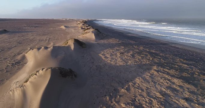 4K aerial tilt-up view of the shoreline of the  Atlantic Ocean on the Skeleton Coast,Namibia