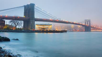 Brooklyn bridge at foggy rainy evening, New York City