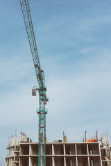 Fototapeta na wymiar Construction crane building new building outdoor. Urban story
