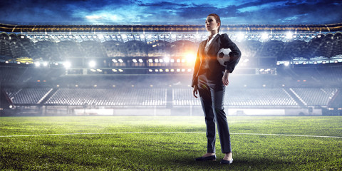 Business lady on football stadium. Mixed media