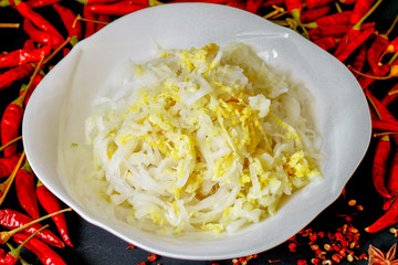 Sauerkraut picked cabbage on a plate with spices in the background