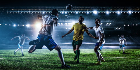 Obraz na płótnie Canvas Soccer players on stadium in action