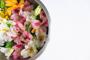Background for text banner on a dark wooden background with white flowers. Blank, frame for text. Greeting card design with flowers. Aalstroemeria on wooden background. View from above