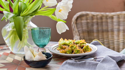 Pumpkin flowers fried in batter. Traditional italian dish. Home dinner and flowers.