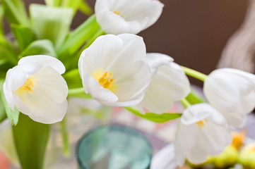 A bouquet of white tulips on a table served for lunch.