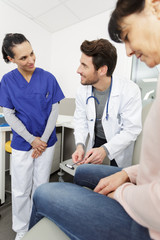 doctor testing knee reflex during medical checkup