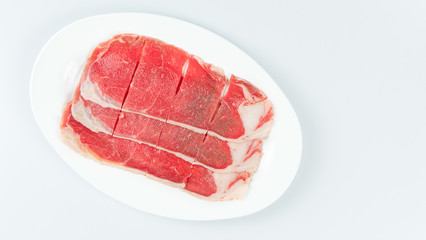 raw beef on a plate .