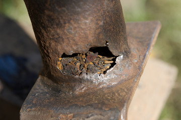 big hole in a rusted pipe at the junction