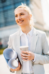 Businesswoman on her way to work. Young manager having coffee.