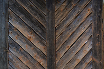 Old  dark rustic wooden barn door. Texture, background 