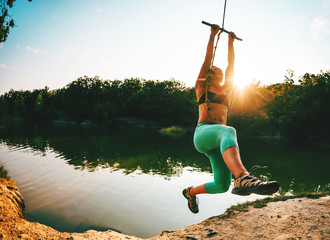 A woman is riding a swing.