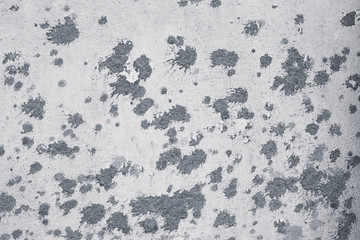 Cement blotches on the white plaster wall texture. Whitewash on the concrete wall. Vintage pattern with cement blotches on white plaster wall background. Architecture backdrop. Cement wall background.