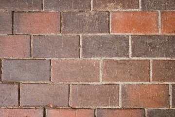 Obraz premium Close up of red brown pavement tiles with scratched texture. Abstract background
