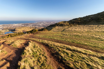 Naklejka premium EDINBURGH, SCOTLAND, 20 February 2019, Cityscape of Edinburgh from Arthur's seat in beautiful February sunny day. Edinburgh, the most popular tourist city destination in Scotland