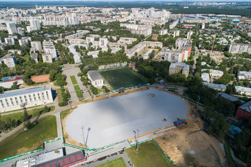 Top down aerial drone image of a Ekaterinburg with stadiums: ready and under construction. Midst of summer, backyard turf grass and trees lush green.