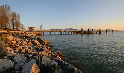panoramic view of a pier in the Trasimeno Lake, Umbria, Italy, during sunset