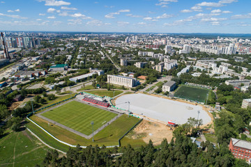 Top down aerial drone image of a Ekaterinburg with stadiums: ready and under construction. Midst of summer, backyard turf grass and trees lush green.