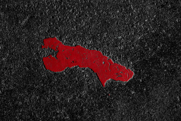 Roter Farbtupfer auf Asphalt