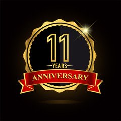 Celebrating 11 years anniversary logo. with golden ring and red ribbon.