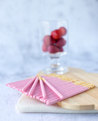 Japanese snack biscuit stick strawberry coated white background.