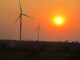wind turbines at sunset