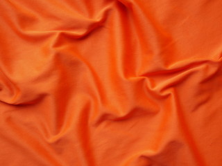 orange sportswear shirt background,silk cloth texture