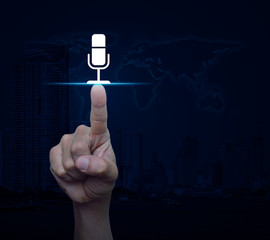 Hand pressing microphone flat icon over world map, modern city tower and skyscraper, Business communication concept, Elements of this image furnished by NASA