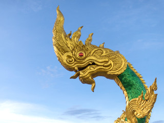 Fototapeta na wymiar Beautiful naga sculpture with blue sky on the sunny day at the public temple