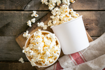 Home made pop corn in white cups on wood background