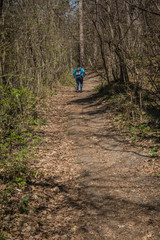 Obraz premium Girl walking in forest on mountain, dressed in blue clothes