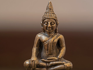 Indoor close-up photography of a bronce buddha statue.