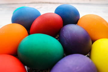 Fototapeta na wymiar several colorful easter eggs on the wooden table closeup