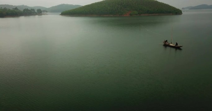 Amazing view of Thac Ba Lake. A fishing boat sailing on the lake. the Vu Linh. It  is a rural commune on the eastern shores of Thac Ba Lake.