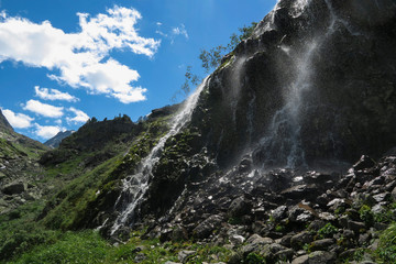 Fototapeta na wymiar Mountain waterfall in sunny day. Altai mountains, Siberia, Russia