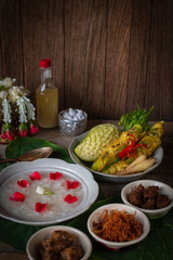 Khao-Chae, Cooked Rice Soaked in Iced Water in the white bowl and Eaten with the Usual Complementary Food and to decorate by flower, scented water.