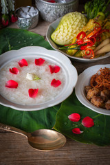 Khao-Chae, Cooked Rice Soaked in Iced Water in the white bowl and Eaten with the Usual Complementary Food and to decorate by flower, scented water.