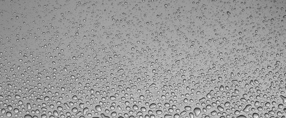 Drops of water on grey metal window sill.